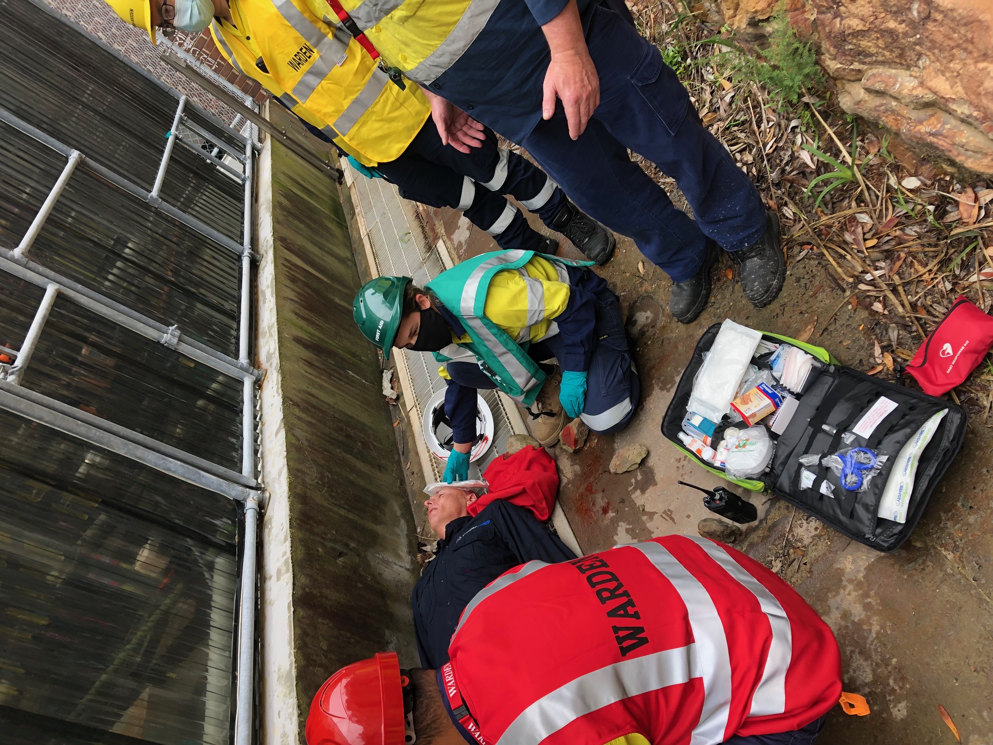 Wardens giving first aid to a casualty during an emergency exercise